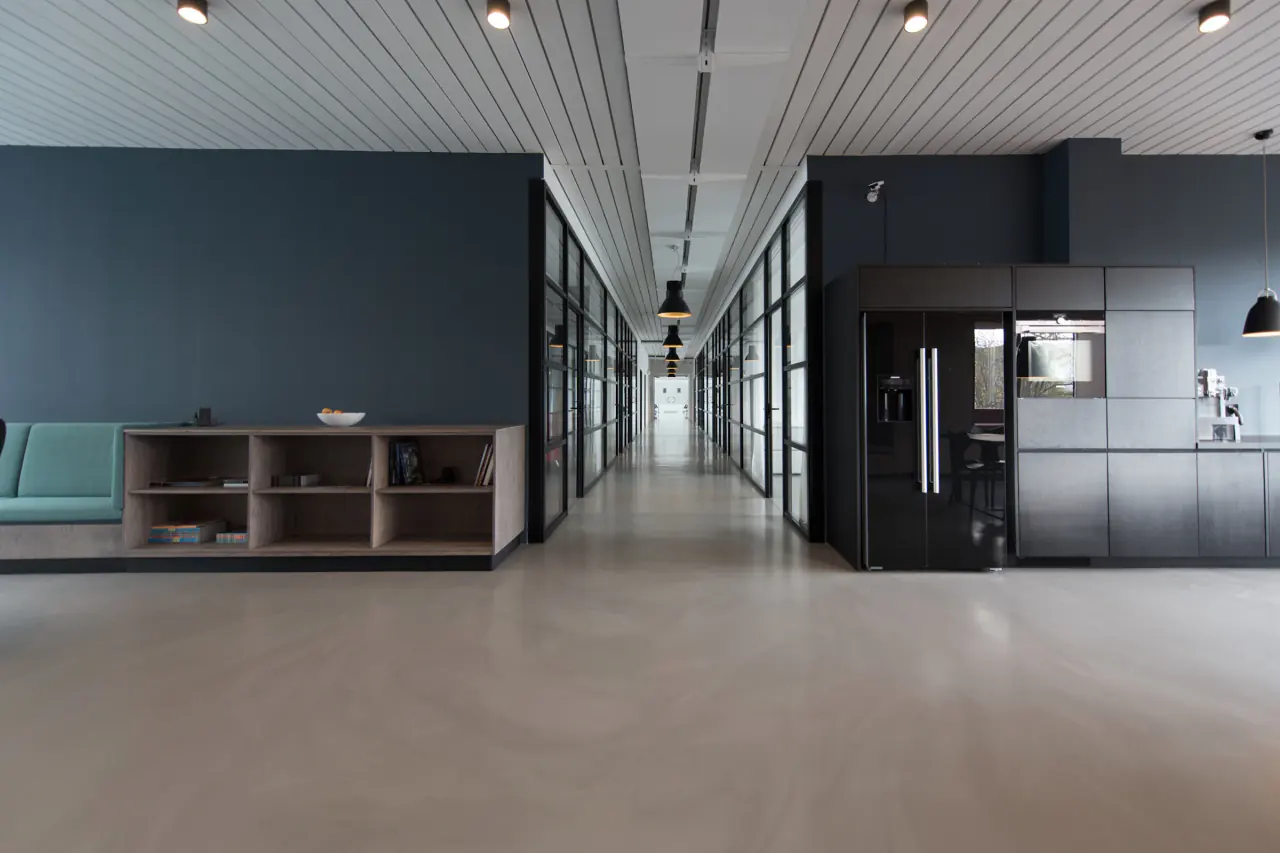 Office interior with shared amenities and a central circulation route